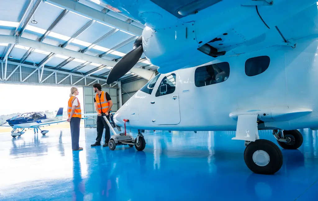 Technicians with a special mission aircraft in a hangar