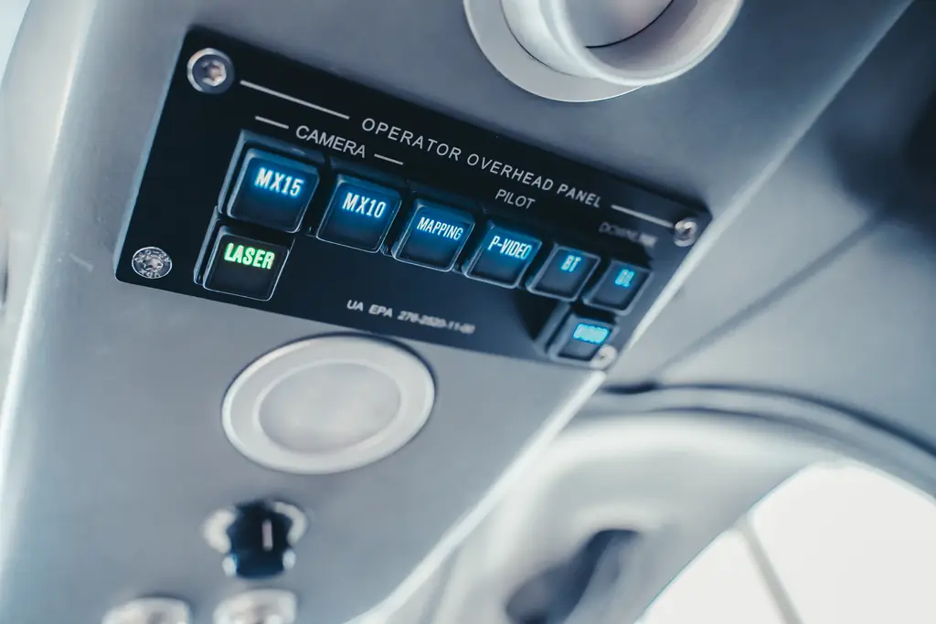 Operator overhead panel with camera and laser switches